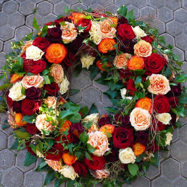 flower delivery Budapest - Funeral wreath with 100 mixed warm color roses