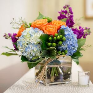 Glass cube with hydrangeas, and summer flowers (13 stems)