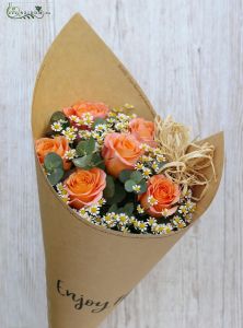 Peach roses and small flowers in craft paper cone
