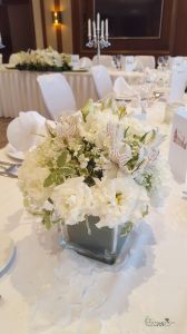 Wedding centerpiece in glass cube (phalaenopsis orchid, lisianthus, alstomelia, white)