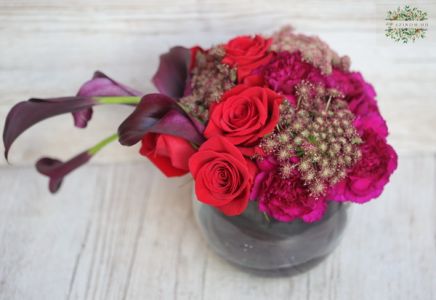 Glass ball with modern composition of burgundy black callas, red roses, carnations (25 stems)