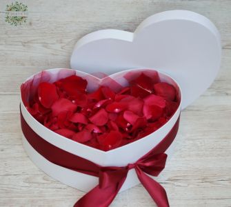 Big heart shaped box filled with red rose petals