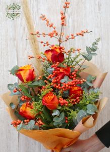 Orange rose bouquet with ilex berries