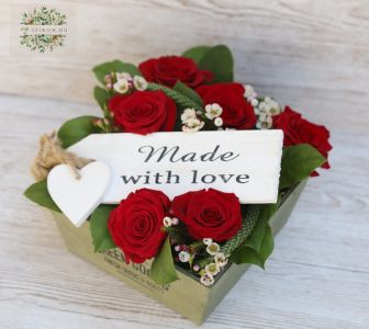Rustic wooden box with red roses and small flowers