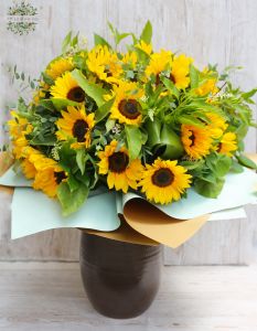 30 sunflowers in a large bouquet with lots of greenery, ceramic vase