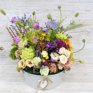 Big zinc bowl with summer meadow style flowers, hedgehog figure (29 stems)