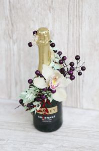 Champagne decorated with dried flowers and orchid
