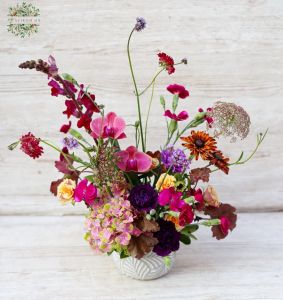 wild flowers and orchids in a small ceramik pot