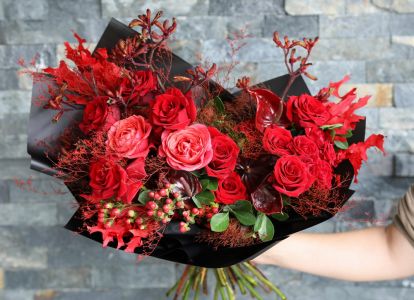 Flaming crescent moon bouquet with red roses