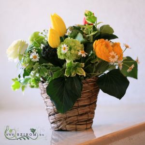 Wedding basket centerpiece of spring flowers (tulips, buttercups, chamomile, yellow)