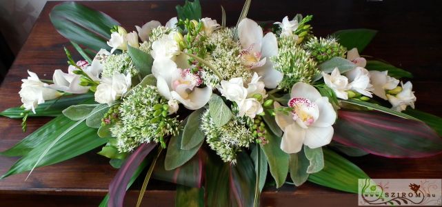 Main table centerpiece with white orchids, sedums and freesias, wedding