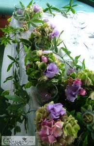Main table centerpiece with passion flowers (hydrangea, lisianthus, purple), wedding
