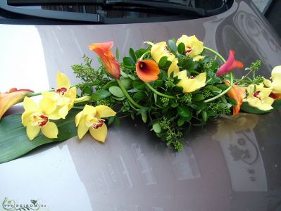 oval car flower arrangement with orchids and callas (yellow, orange)