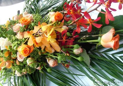 oval car flower arrangement with orchids (rose, orange, peach)
