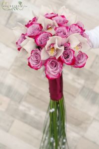 Bridal bouquet with purple roses, white orchids, bear grass tail