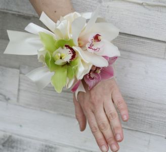 wrist corsage made of orchids (white, green, pink)