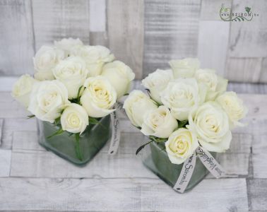 Flower arrangement in glass cube with white roses, wedding