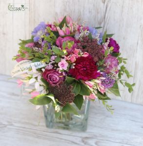 Meadow flowers in glass cube, with purple rose