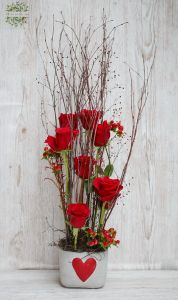 7 red roses in a concrete pot