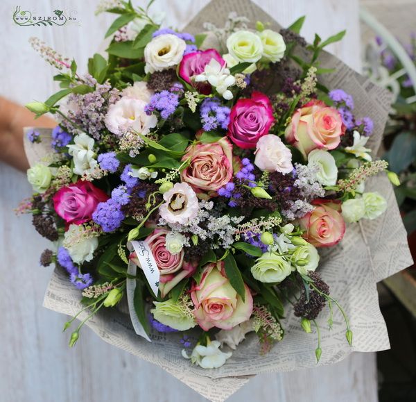 Big bouquet with meadow flowers and roses