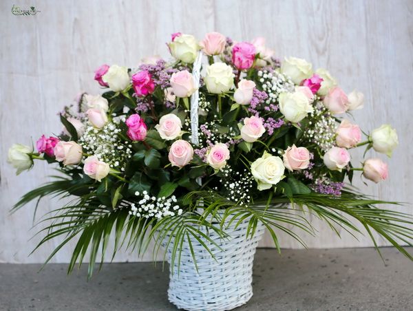 40 stems of pastel roses in basket with small flowers