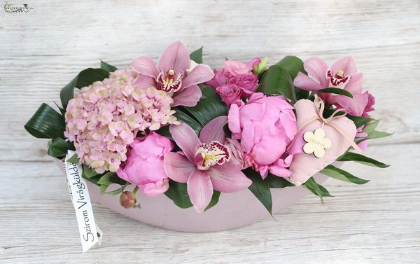 Pink flowerboat, with orchids and hydrangeas