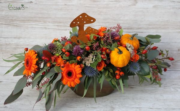Autumn arrangement in boat shaped bowl with mushrooms