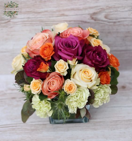 Glass cube with peach - purple roses, carnations (30 stems)