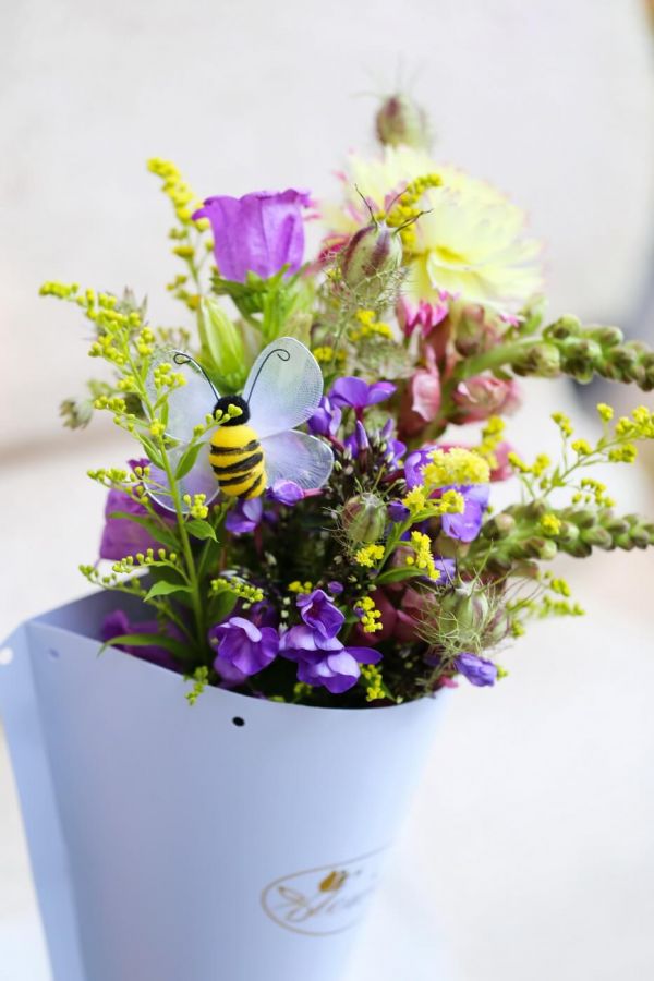 Meadow type flowers in paper cone, with bee (13 stems)