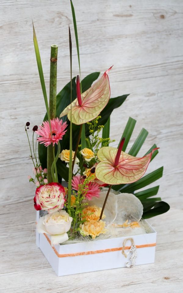 Summer tropical sandy beach flower box with flamingo flower, comb shell