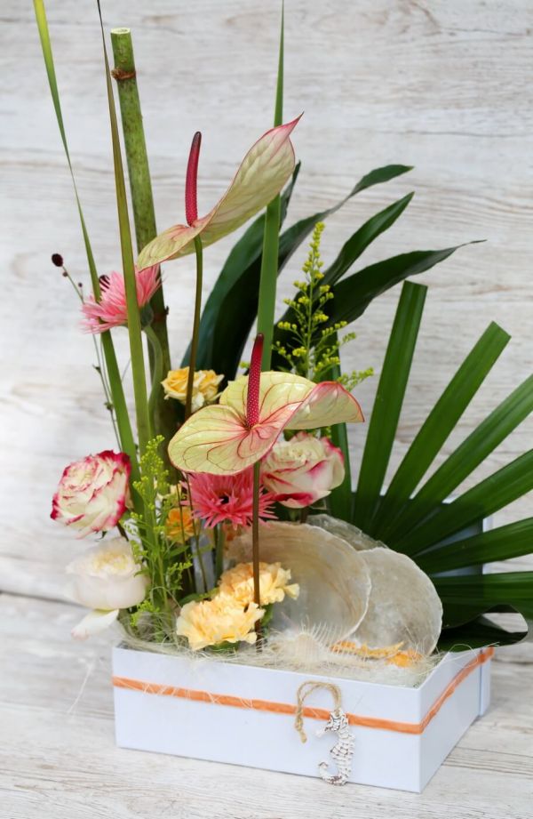 Summer tropical sandy beach flower box with flamingo flower, comb shell