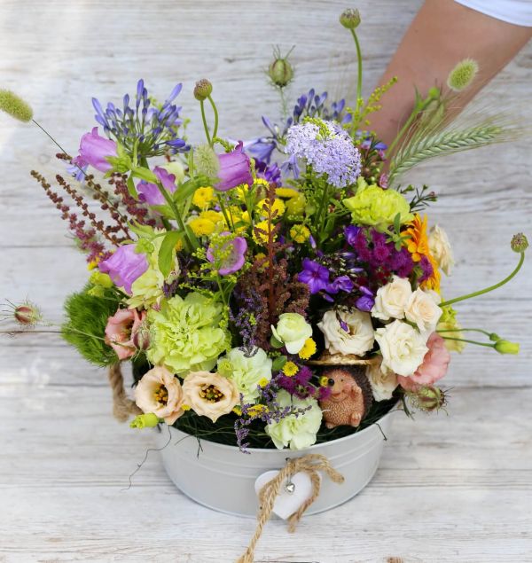 Big zinc bowl with summer meadow style flowers, hedgehog figure (29 stems)