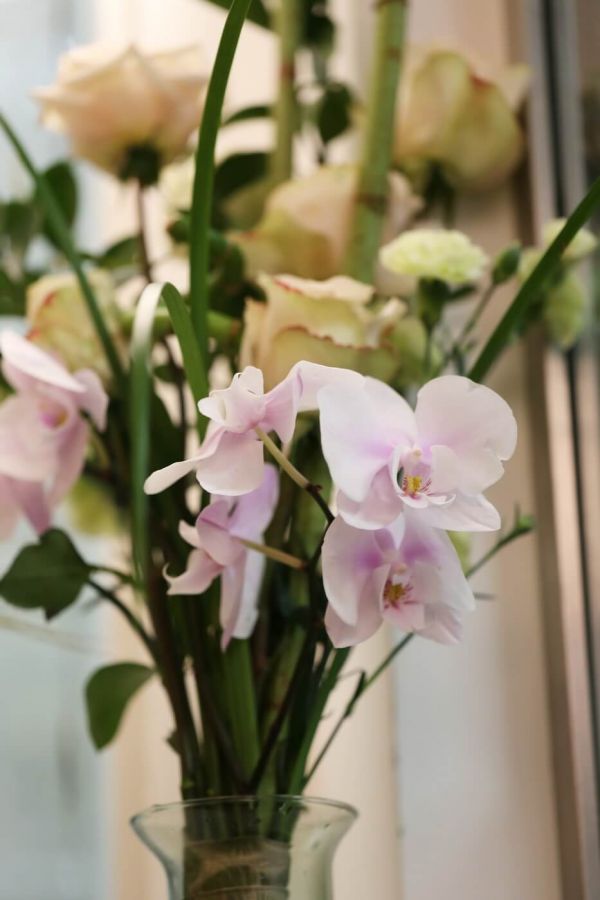 Oriental rose bouquet with orchid stem, vase