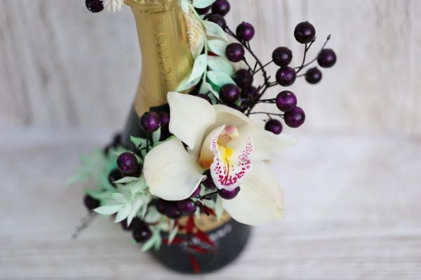 Champagne decorated with dried flowers and orchid