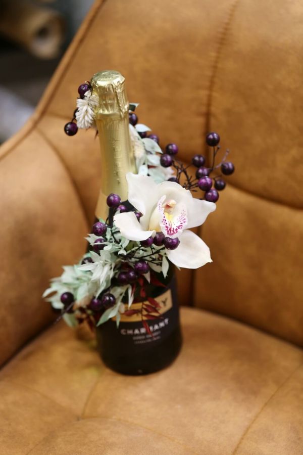 Champagne decorated with dried flowers and orchid