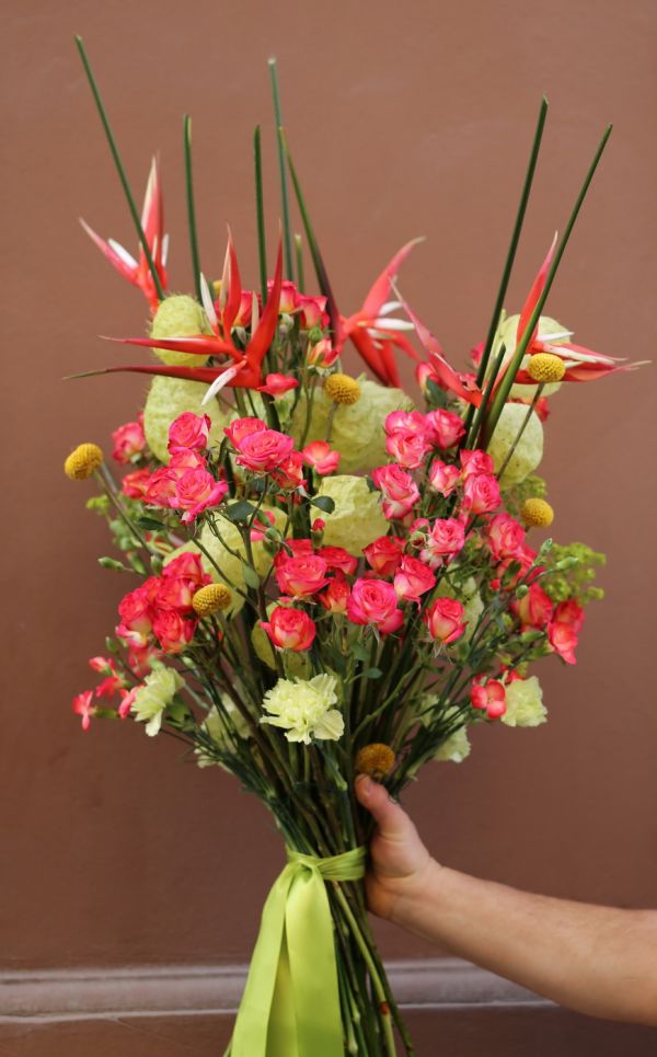 Airy bouquet with heliconias, spray roses, and asclepias balls