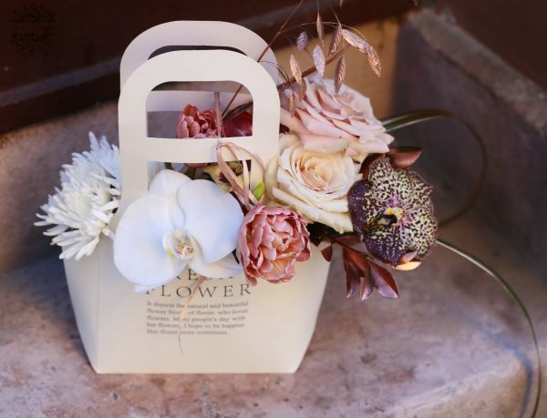 Modern elegant feminine bag bouquet with orchids, in theme color of the year Mocha Mousse