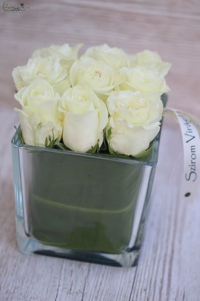 glass cube with 9 white roses