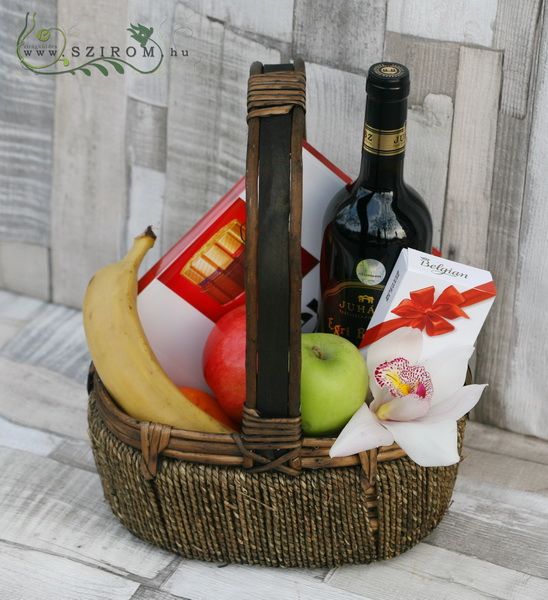 Gift basket with fruits, wine, chocolates, orchid
