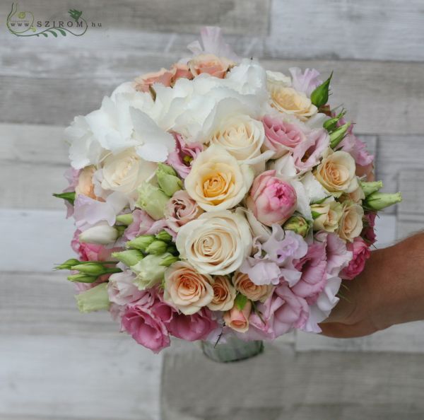 Bridal bouquet with white hydrangeas, peach and pink roses and lisianthusses