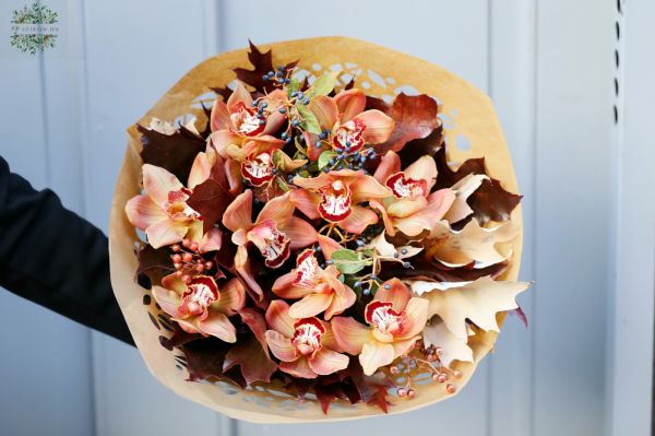 Beautiful peach orchids in autumn bouquet