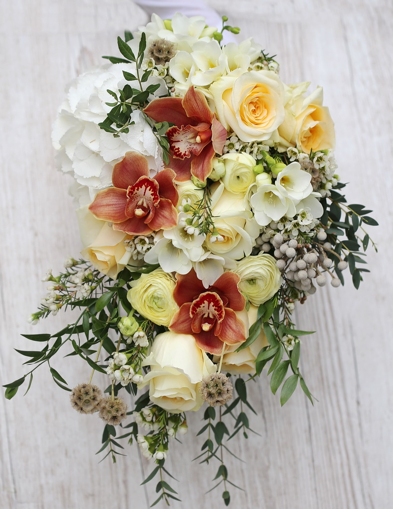 Teardrop bridal bouquet (creme rose, buttercup, orange orchid, white freesia, hydrangea, scabiosa, brunnia, wax)