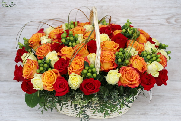 flower delivery Budapest - 60 warm color roses with green berries in basket