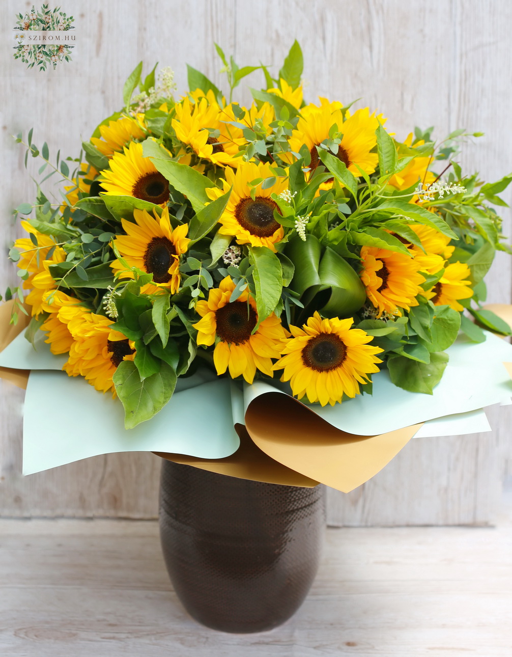 flower delivery Budapest - 30 sunflowers in a large bouquet with lots of greenery, ceramic vase